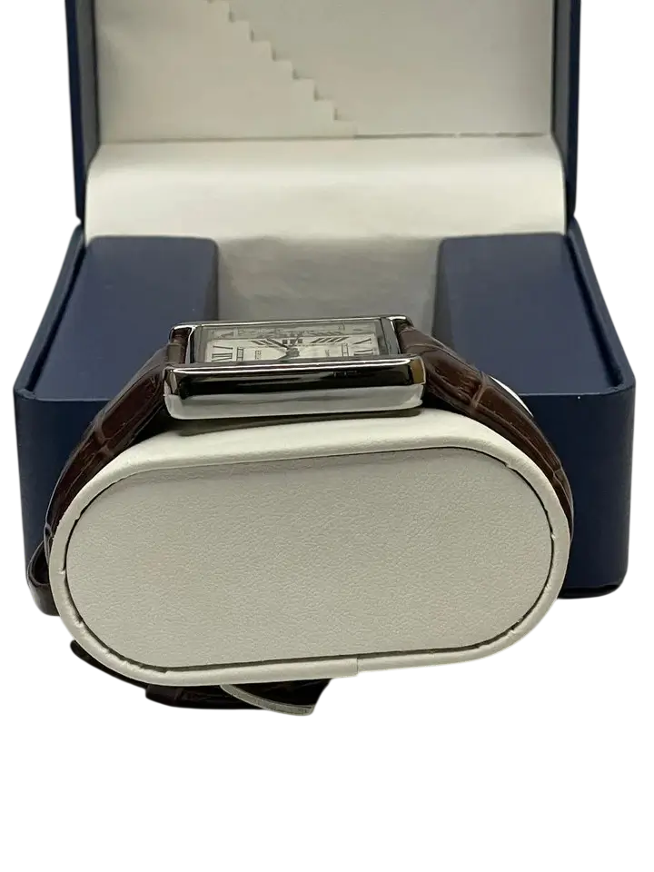 Cartier Tank watch on white pillow inside luxury watch box - side view