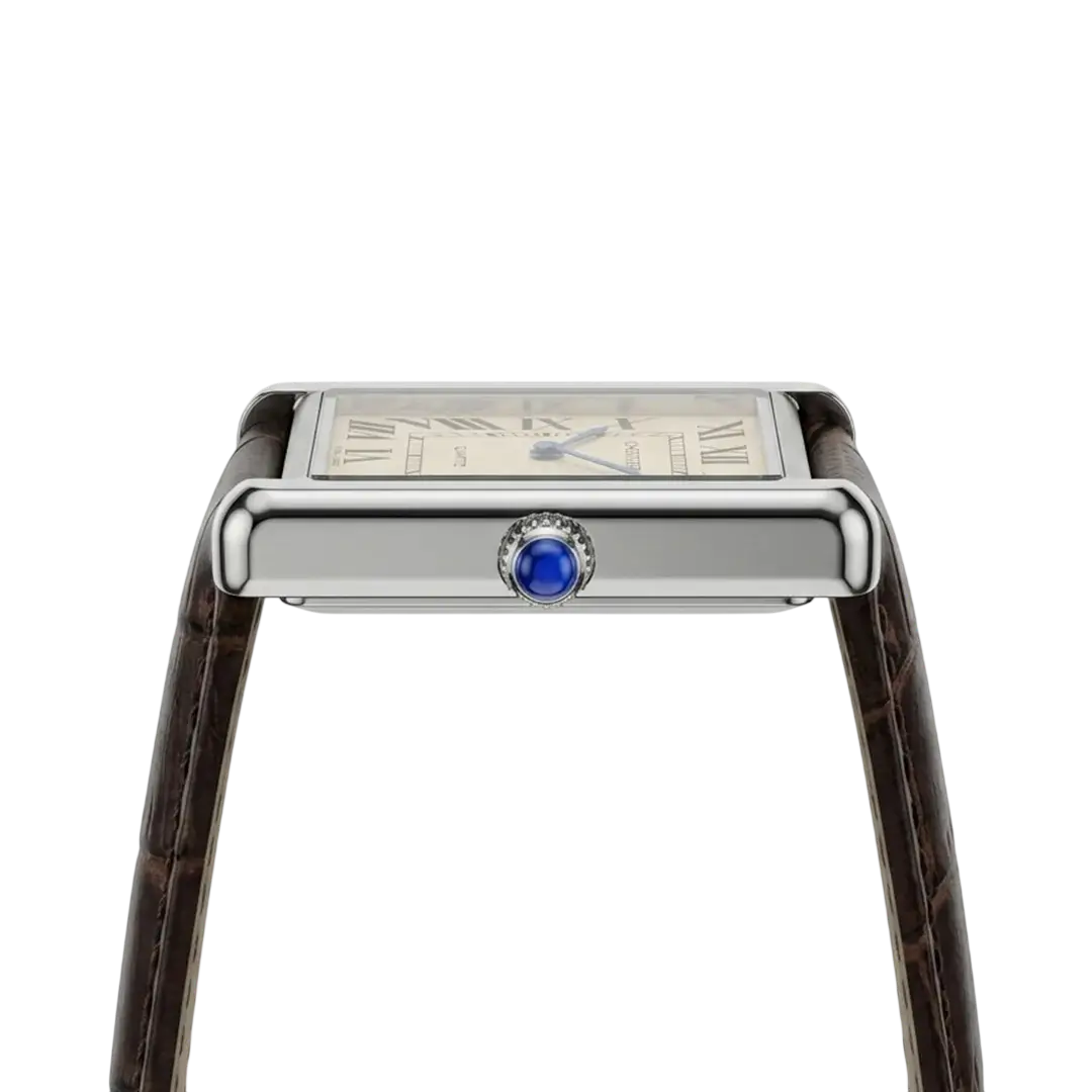 Side profile of Cartier Tank watch showing blue sapphire crown and stainless steel case